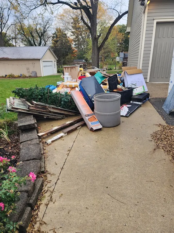 Dumpster being loaded with debris for Estate Cleanout Dumpster Rental in Dilley